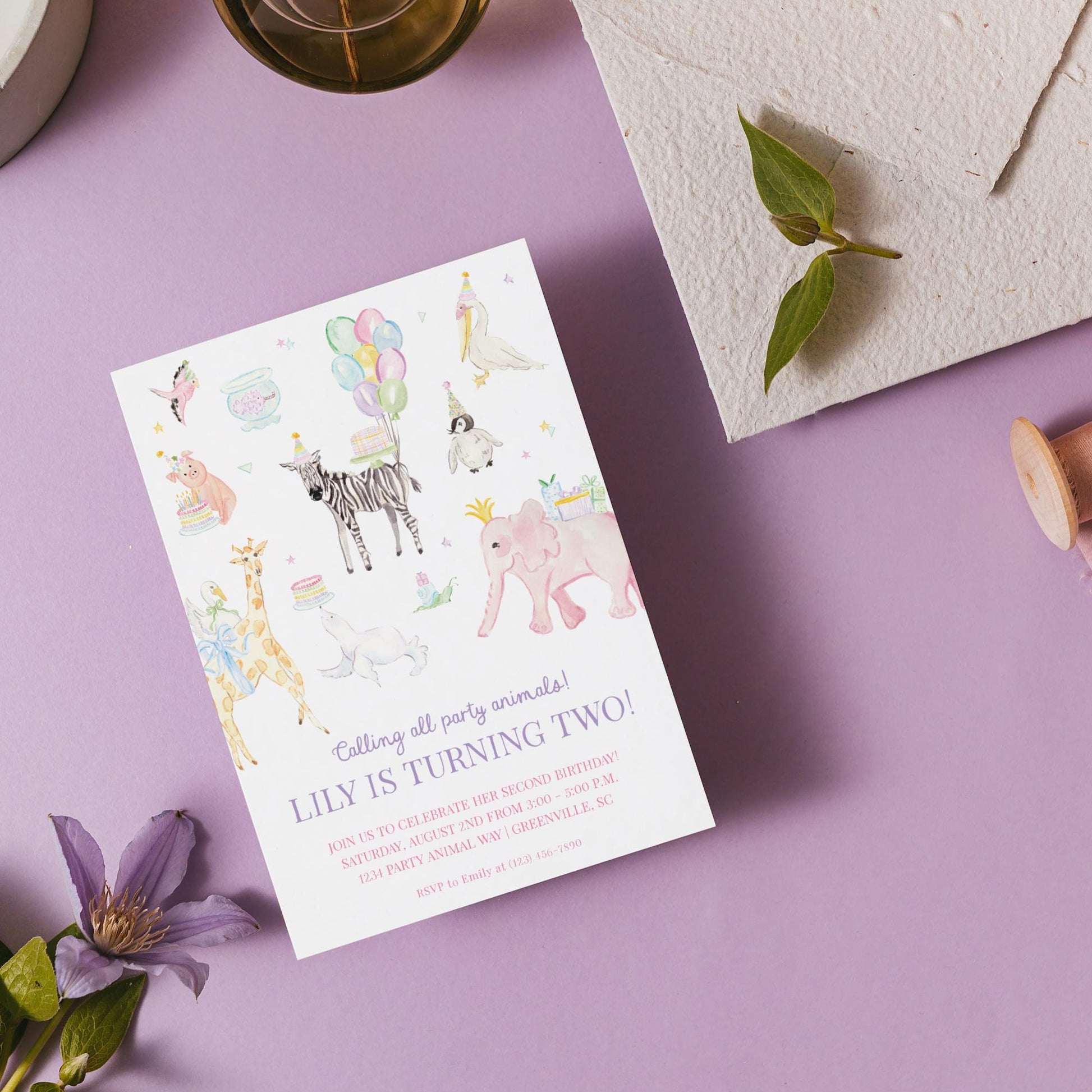 A birthday invitation card for a two-year-old birthday party, featuring illustrations of various animals and a purple background.