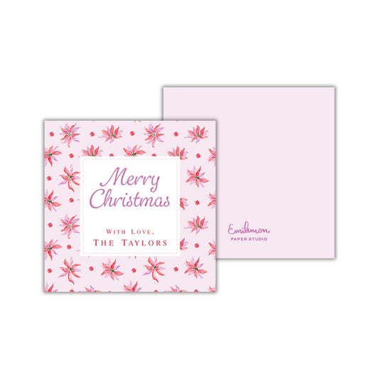 The image is a pink Christmas card with a floral pattern and the text "Merry Christmas with Love, The Tylors" printed on it.