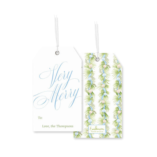 two white tags with text and designs, hanging from strings.