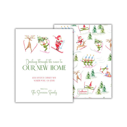 The image is a white card with a festive holiday-themed design, featuring illustrations of Santa Claus, reindeer, and snowmen. The card is addressed to "The Skivan Family" and includes a message about the family's new home.