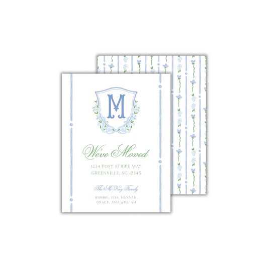 a white and blue wedding card with a monogrammed initial