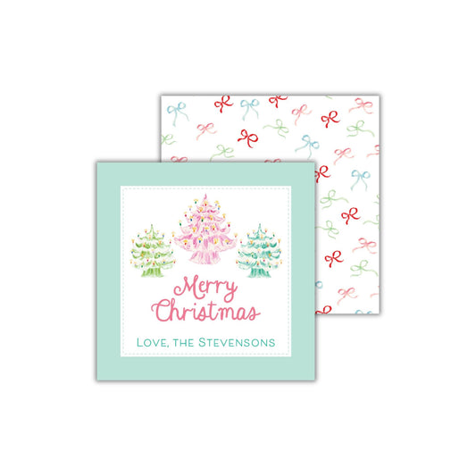 A Christmas card with a festive design featuring three Christmas trees and the text "Merry Christmas" and "Love, the Stevensons".