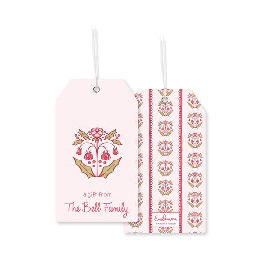 two identical tags with a floral design and text, hanging from strings.