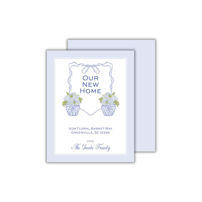 a blue and white card with flowers in a basket