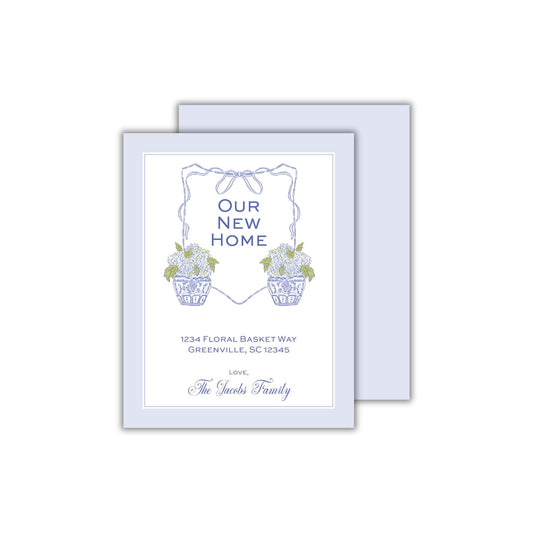 a blue and white card with flowers in a basket