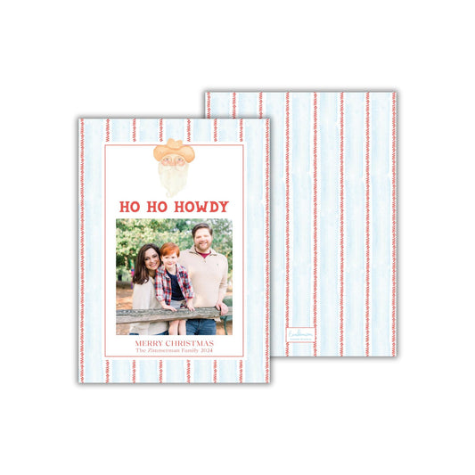 A holiday card featuring a family photo with the text &quot;HO HO HOWDY&quot; and &quot;MERRY CHRISTMAS&quot; printed on it.