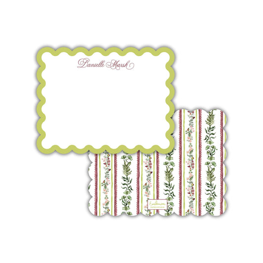 a white scalloped card with a floral pattern on it.