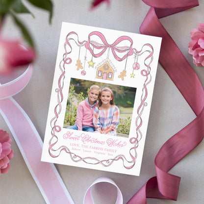 A white card with a pink ribbon and a photo of two young girls, surrounded by pink flowers and a pink ribbon.
