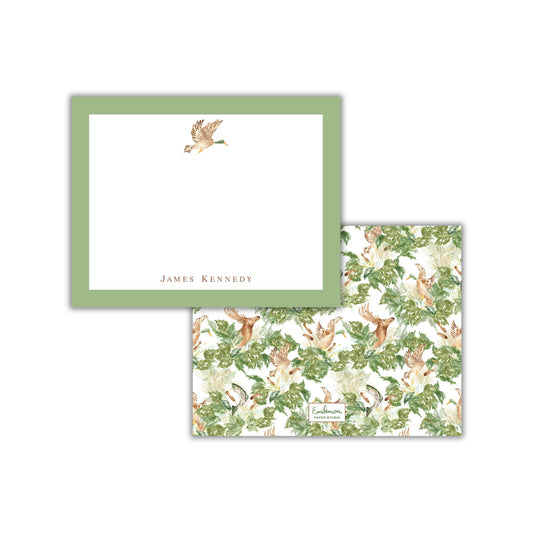 a square note card with a green border and a white background, featuring a watercolor illustration of a bird in flight. The card is set against a white background, and the text "James Kennedy" is printed on it.