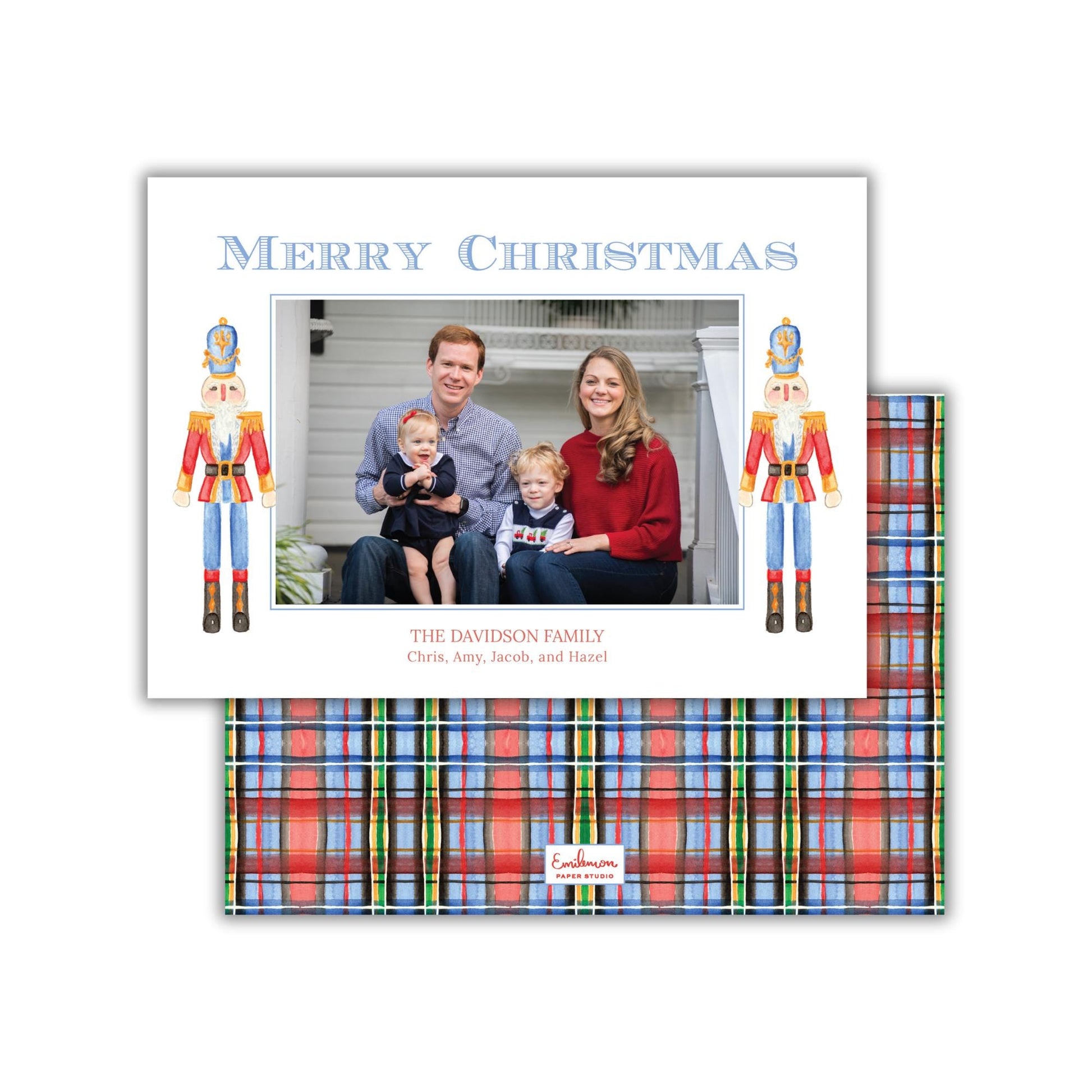 A family portrait of a man, woman, and child, with nutcracker figures on either side of the photo. The text &quot;Merry Christmas&quot; is displayed above the photo, and &quot;THE DAVIDSON FAMILY Chris, Amy, Jacob, and Hazel&quot; is written below the image.