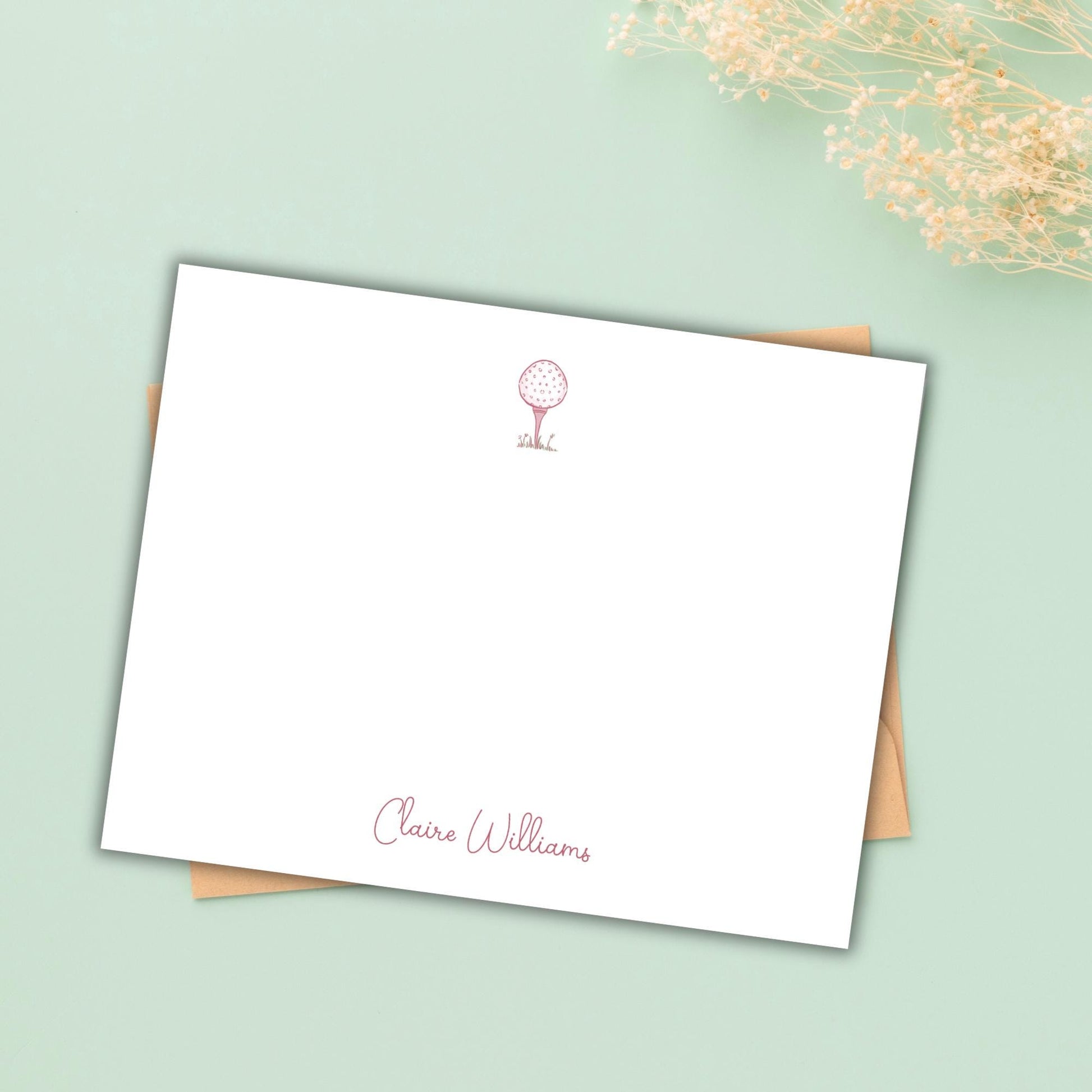 A blank white card with a personalized message and a small red golf club icon on the top left corner, placed on a light green background.