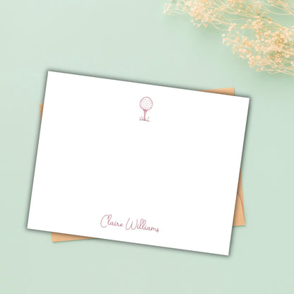 A blank white card with a personalized message and a small red golf club icon on the top left corner, placed on a light green background.