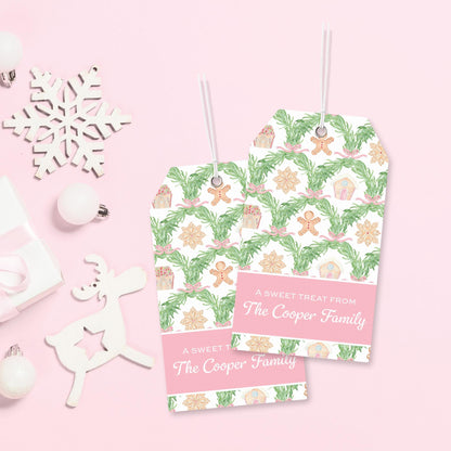 two tags with a festive holiday pattern, hanging on a pink background. There are also some ornaments and a snowflake decoration in the background.