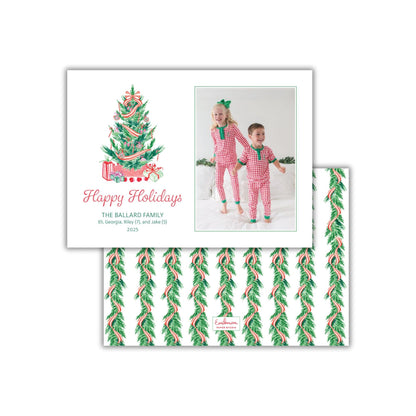 A holiday card featuring a Christmas tree with presents and two children in pajamas, along with a photo of the children.