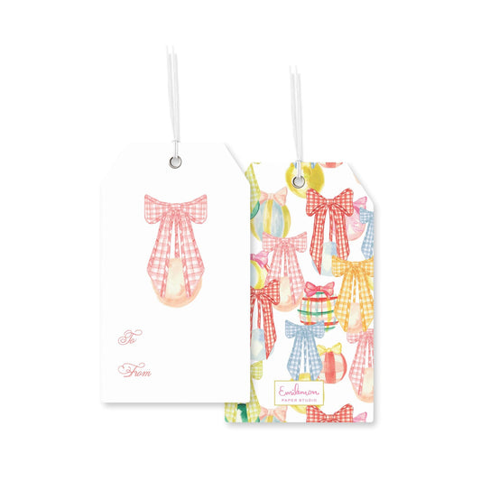 two gift tags with a checkered bow design. The tag on the left has a bow and the text &quot;To From&quot; written on it, while the tag on the right has a pattern of colorful bows and the text &quot;Ella&#39;s Studio&quot; on it.