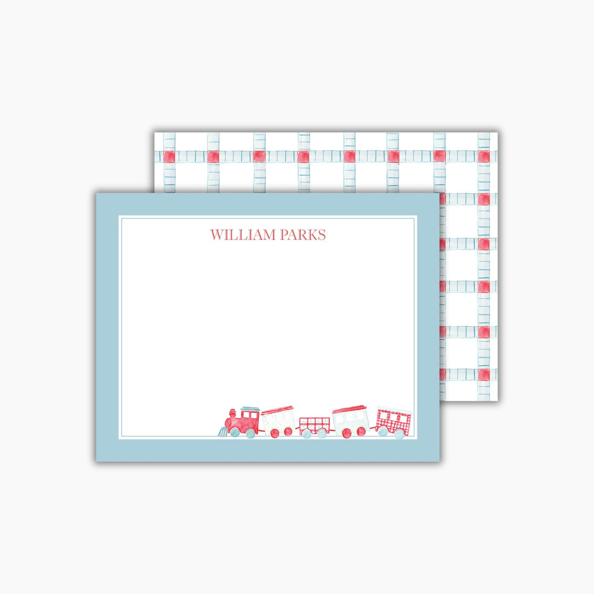 A rectangular notecard with a light blue border and a hand-painted watercolor train in red and blue is in the bottom right corner. The child's name is at the top in a classic red font. The back features a light blue and red geometric pattern.