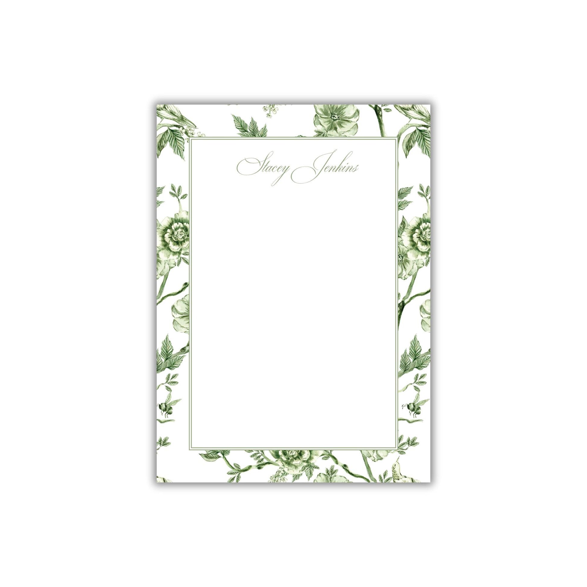 a card with a green floral design on it
