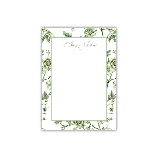 a card with a green floral design on it