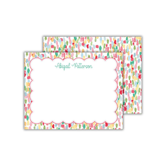 a personalized note card with a scalloped edge and a colorful, abstract background. The card has a blank space for writing a message, and the name &quot;Abigail Patterson&quot; is written in cursive.