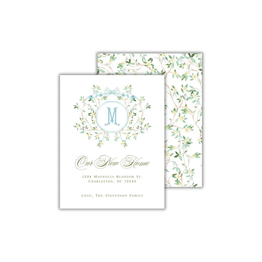 two folded cards with a monogrammed wreath on them