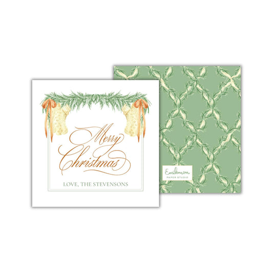 a Christmas card with a festive design, including a wreath, bells, and text that reads &quot;Merry Christmas&quot; and &quot;Love, The Stevensons&quot;.