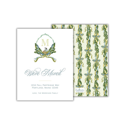 The image is a white card with a floral pattern and a monogrammed letter "M" on it. The card announces that someone has moved to 1234 Fall Partridge Way in Portland, Maine, and invites the recipient to love the Morrison family.