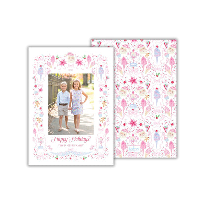 A holiday card featuring two children, likely siblings, standing together in front of a festive background with various holiday-themed illustrations.
