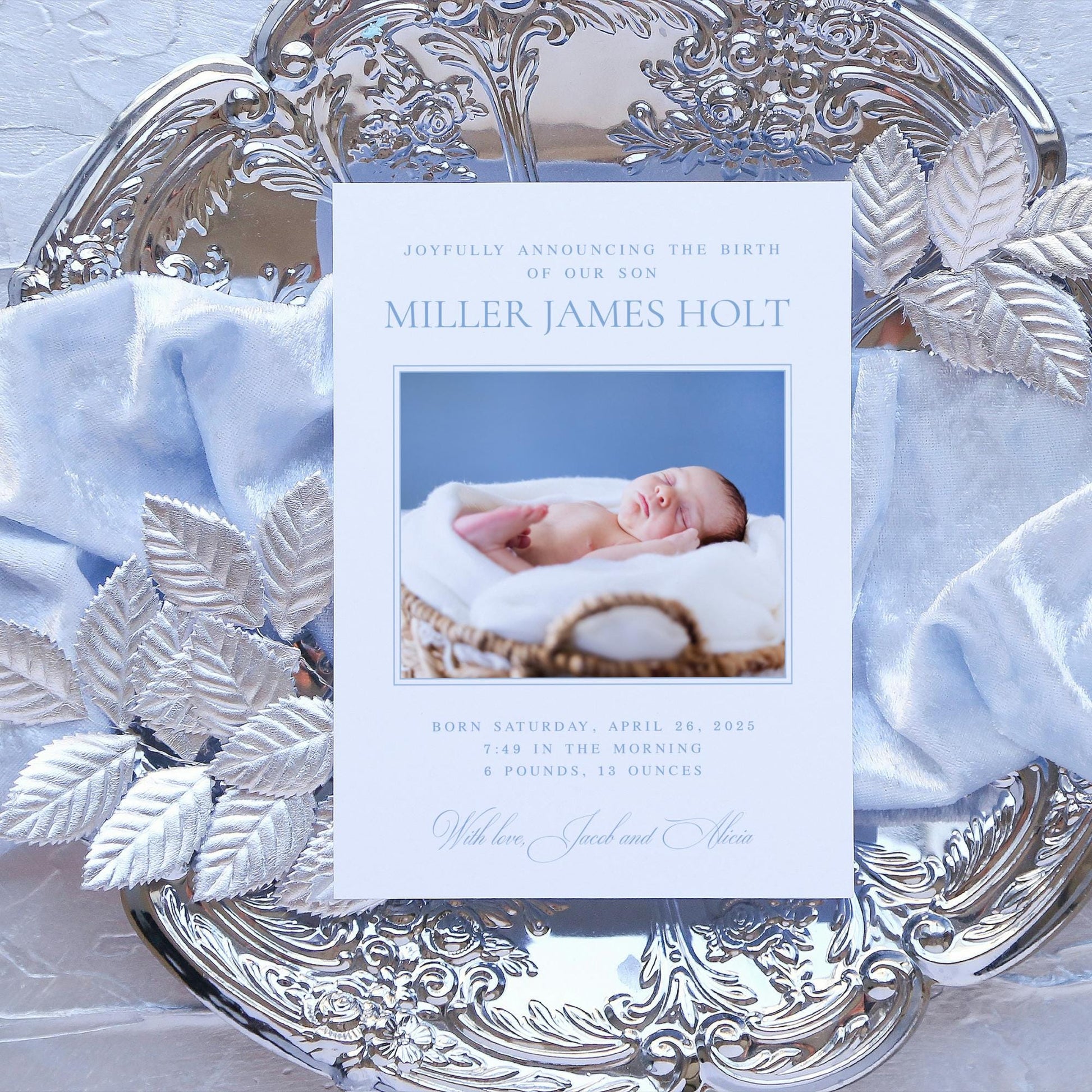 a silver plate with a baby&#39;s picture on it