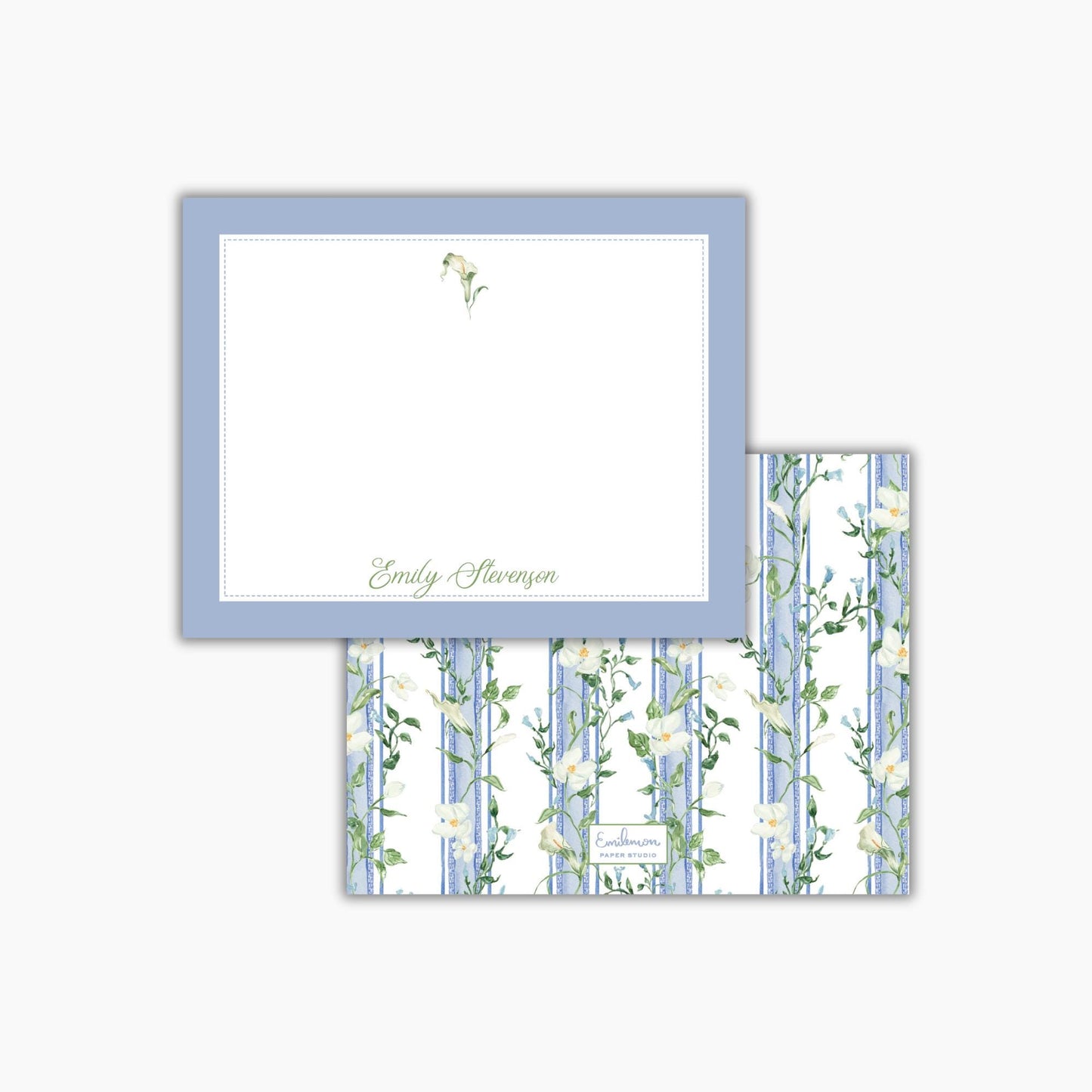 a blue and white floral patterned card with a blank white card frame on top of it.