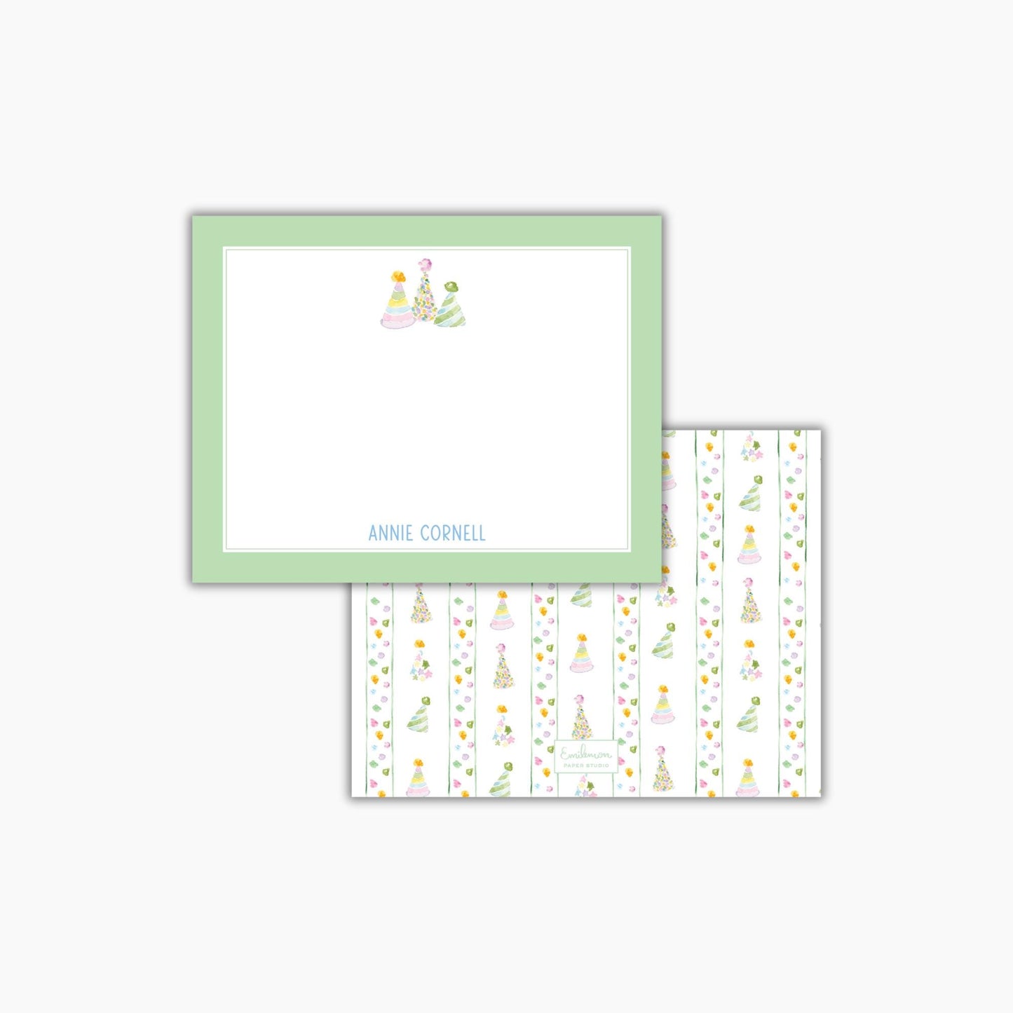 The image is a green-framed note card with a white background and a pattern of colorful Christmas trees on it.