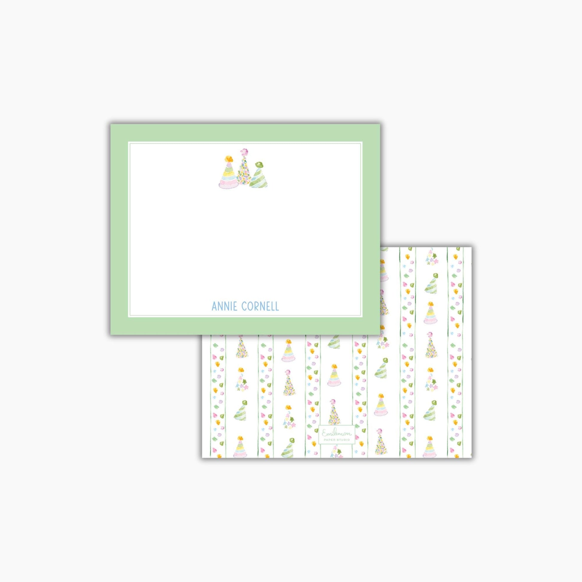 The image is a green-framed note card with a white background and a pattern of colorful Christmas trees on it.