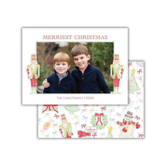 A Christmas-themed photo frame with two young boys smiling and posing for a picture. The frame is decorated with nutcracker figures and other holiday-themed illustrations.