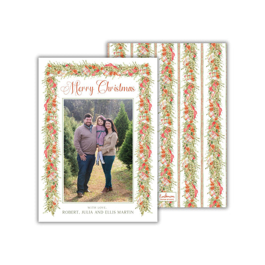 A family portrait of a man, woman, and child standing together in a natural setting, surrounded by a decorative wreath.