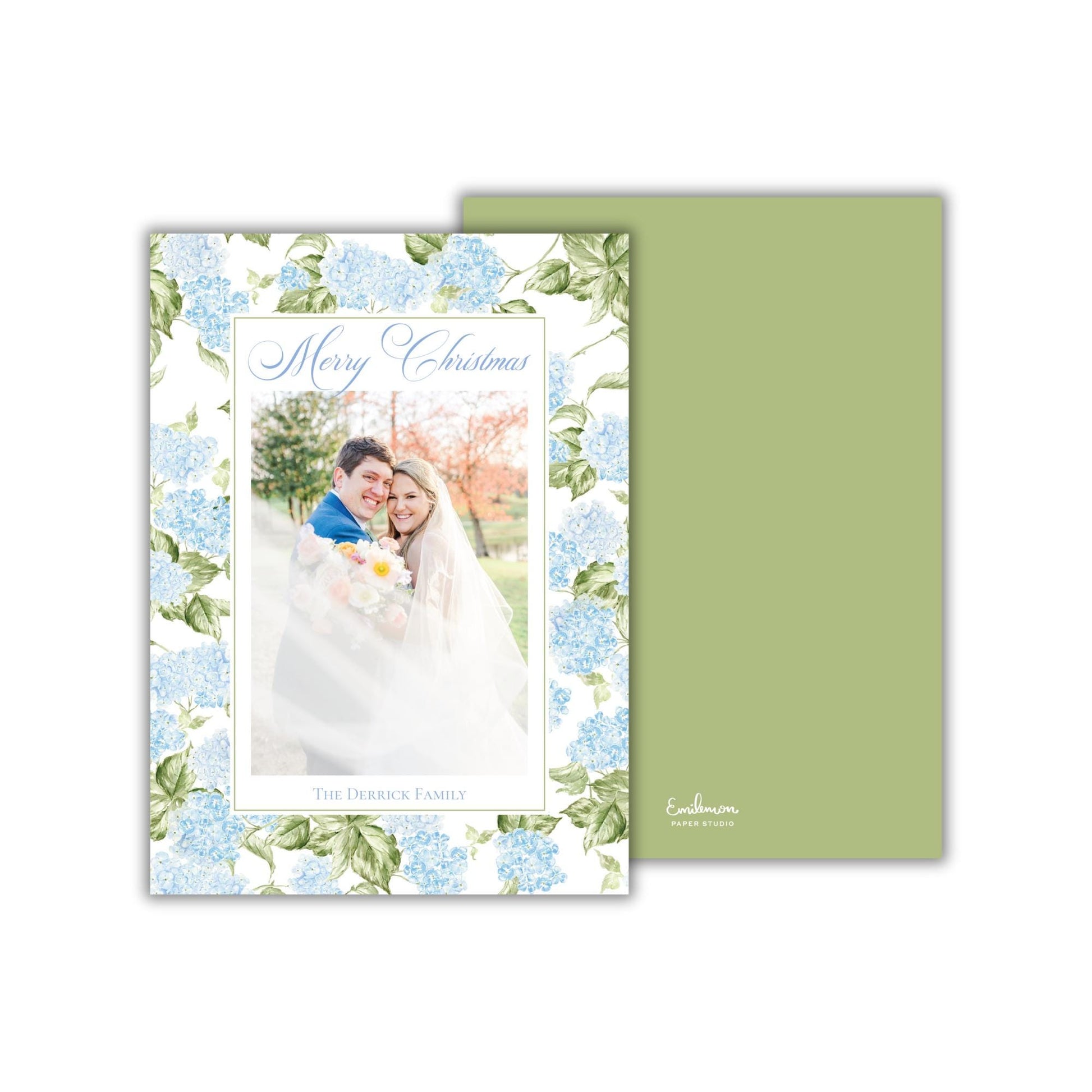 A wedding card featuring a couple embracing in front of a floral background.