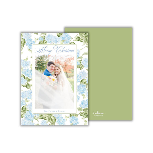 A wedding card featuring a couple embracing in front of a floral background.