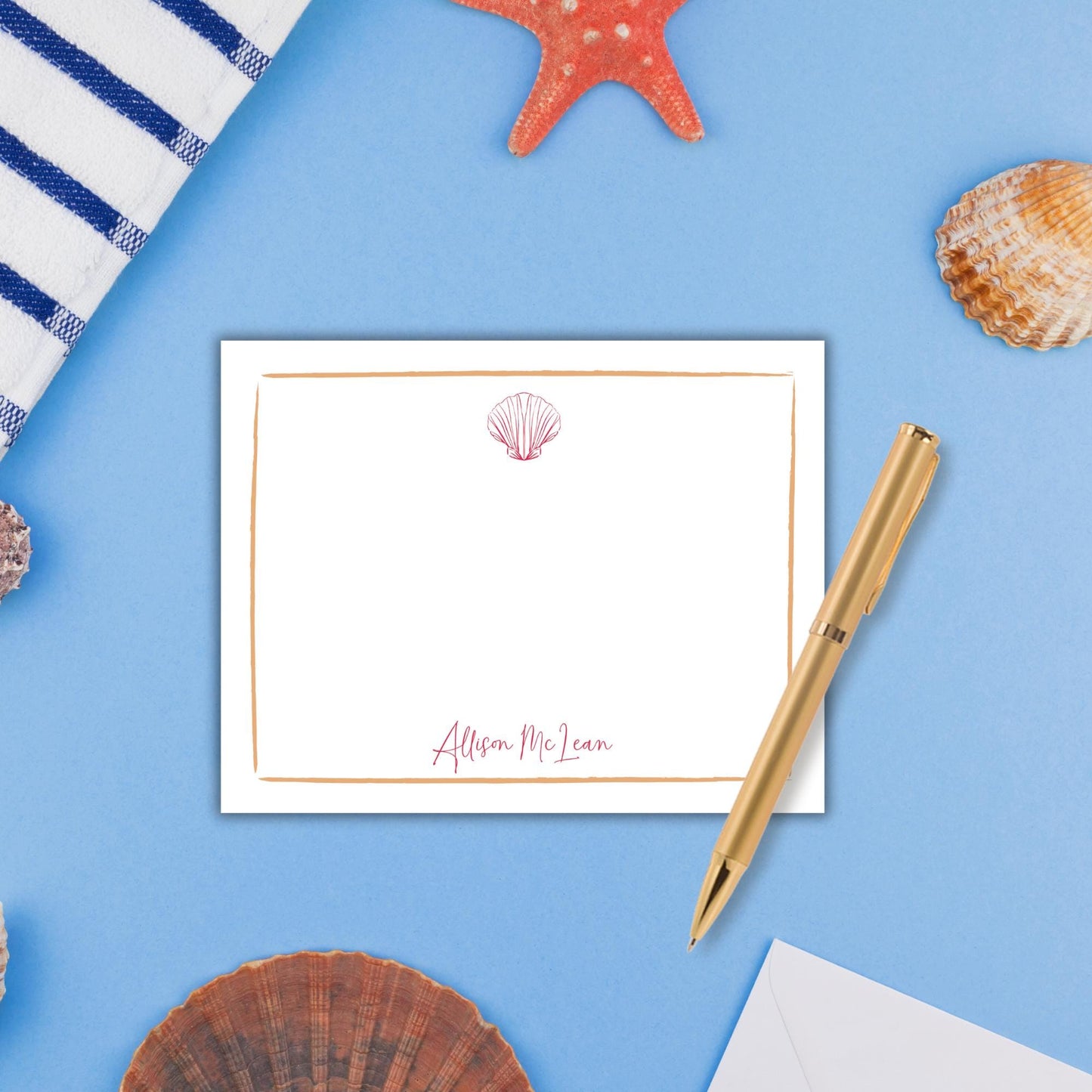 a note card with a seashell and starfish on a blue background