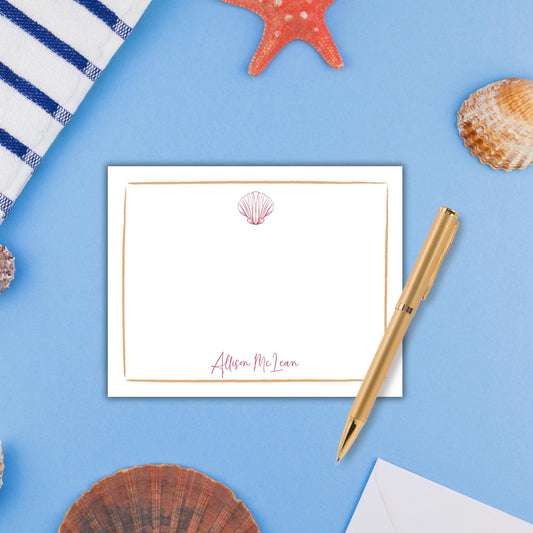 a note card with a seashell and starfish on a blue background