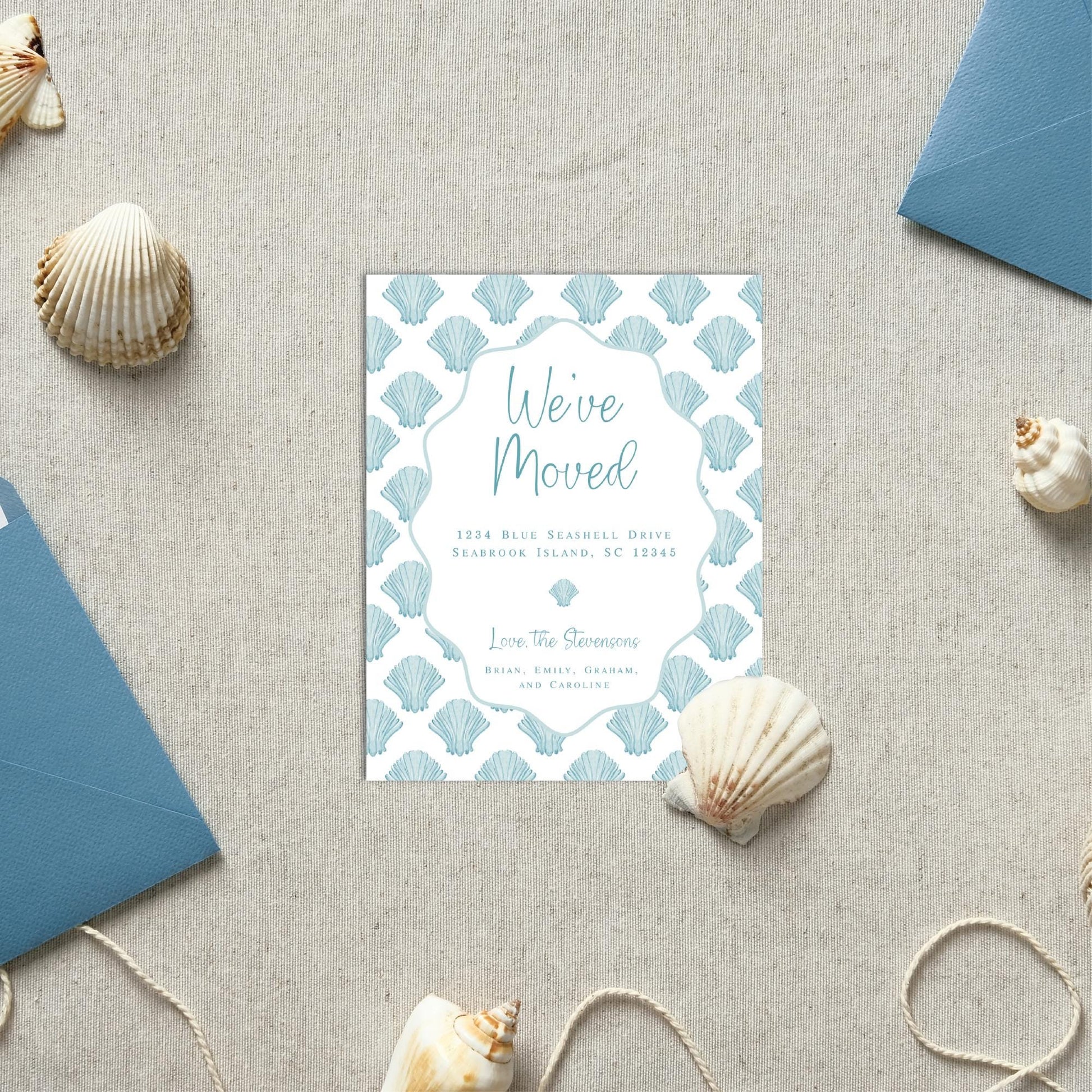 a blue and white wedding card on a table