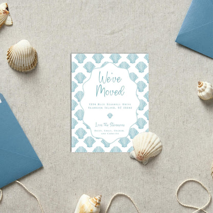 a blue and white wedding card on a table