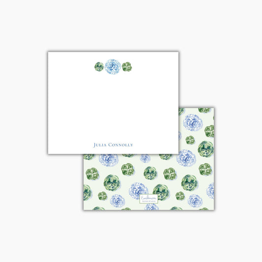 a white square with a floral pattern on it, and below it, there is a smaller square with a similar floral pattern.