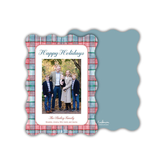 A family portrait of a family, including a man, a woman, and their two children, taken outdoors in a natural setting.