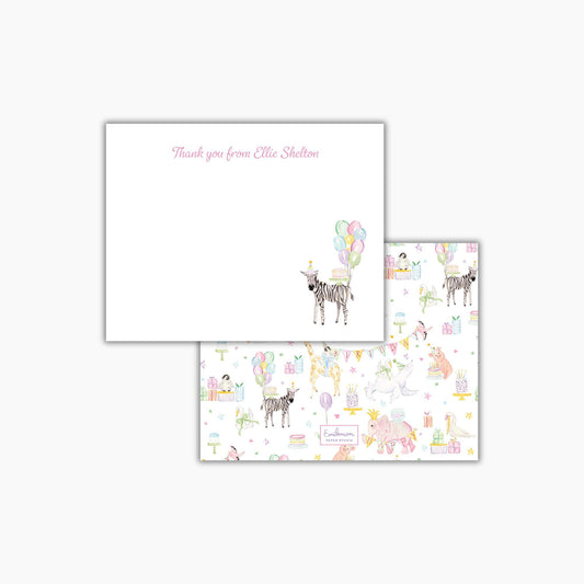 a white card with a pink message and a pattern of various animals, including zebras, giraffes, and elephants, along with balloons and other decorative elements.