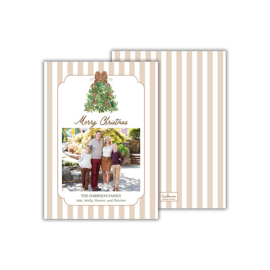 A family portrait of a group of people, likely a family, with a Christmas tree in the background. The text on the card reads &quot;Merry Christmas&quot; and &quot;The Harison Family&quot; along with the names &quot;Jake, Molly, Hunter, and Fletcher&quot;.