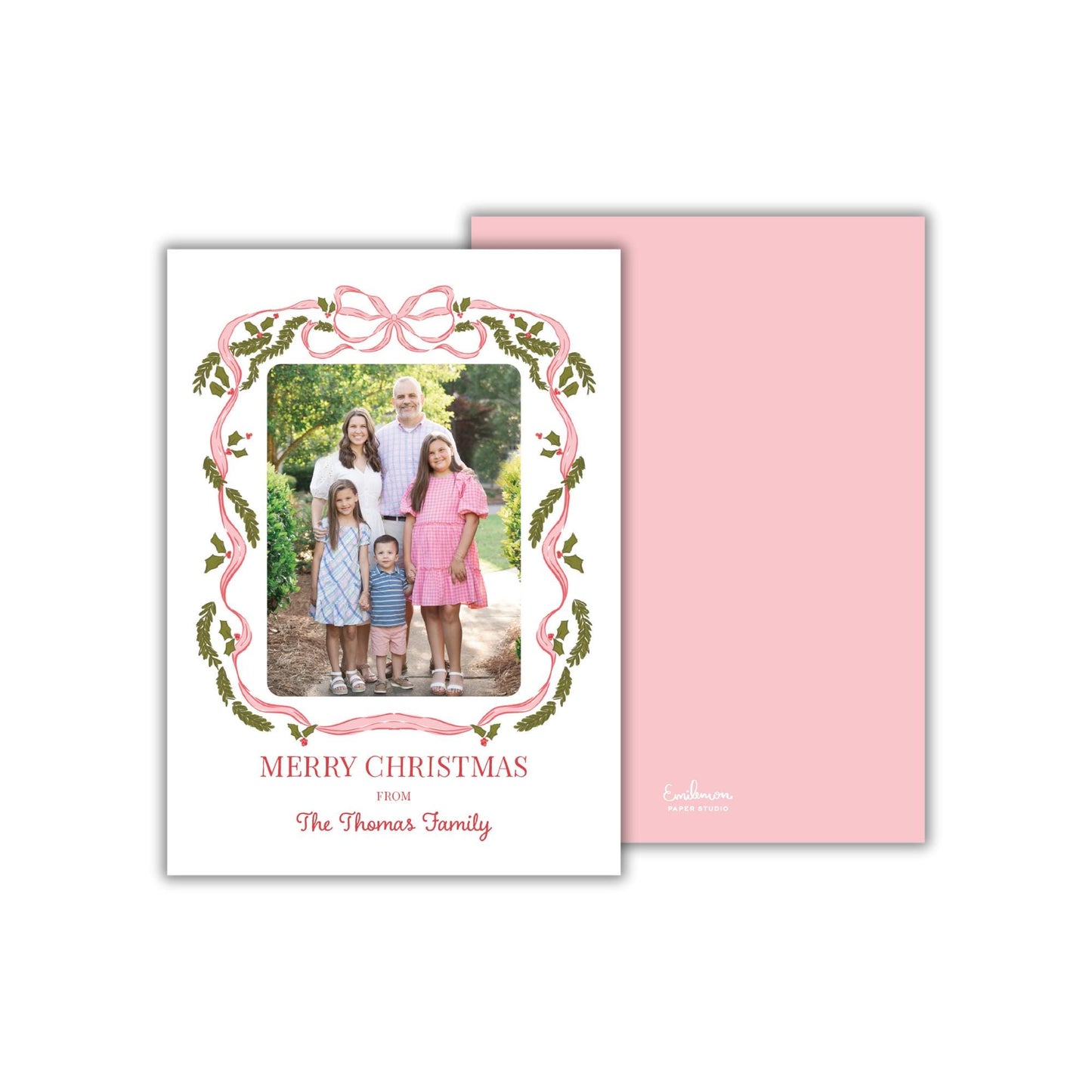 A family portrait of a group of people, likely a family, with a pink and green decorative border around the photo. The text &quot;MERRY CHRISTMAS FROM The Thomas Family&quot; is displayed on the card.