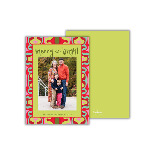 A family portrait of a man, woman, and child, with the text &quot;Merry + Bright&quot; written above the photo.