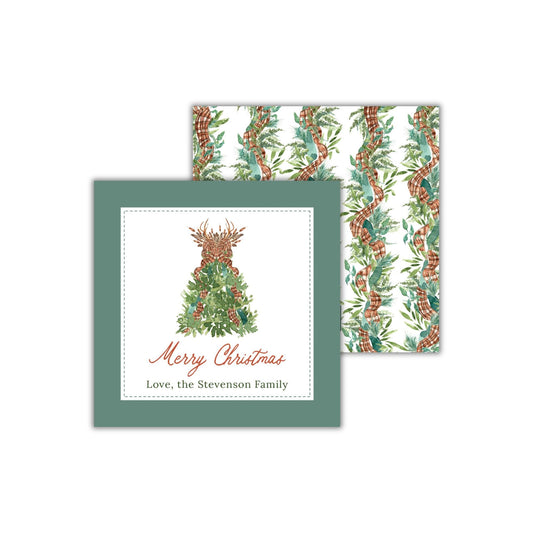 A Christmas card with a tree design and the text "Merry Christmas Love, the Stevenson Family" printed on it.