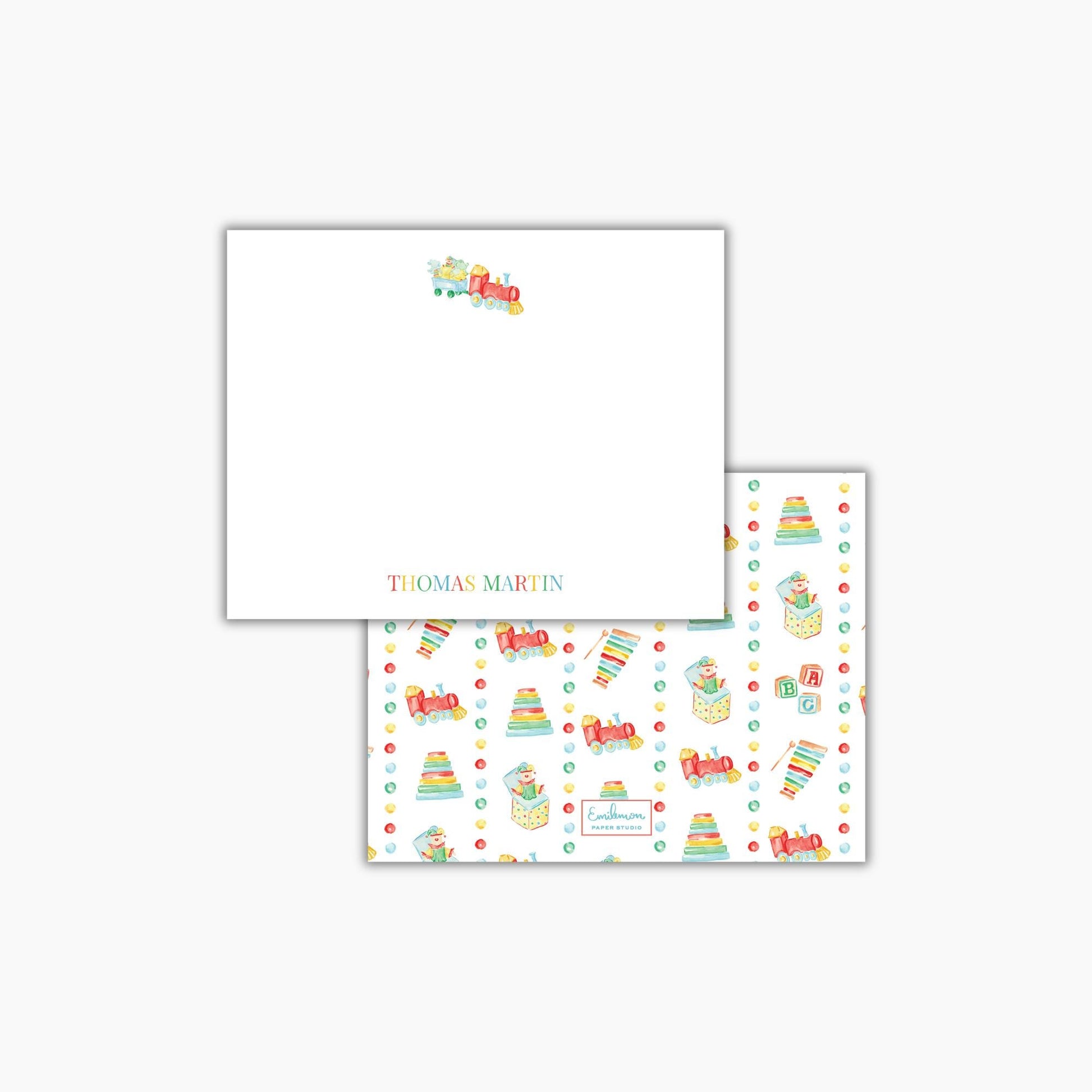 The image is a white square with a train design and a repeating pattern of colorful toy trains on the right side.