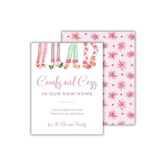 The image is a greeting card with a pink and white color scheme, featuring illustrations of people wearing pajamas and socks. The card has a text that reads &quot;Comfy and Cozy in our new home&quot; and includes the address &quot;1234 Poinsettia Way, Greenville, SC 12345&quot;.