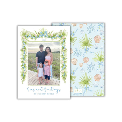 A family portrait of a man, woman, and two children, with a floral border and the text "Seas and Greetings The Corbin Family" printed on the card.