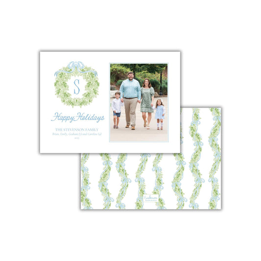 A family portrait of a man, woman, and two children, with a wreath design above them. The text below the portrait reads &quot;Happy Holidays BRITT, EMILY, AND FAMILY of THE STEVENSON FAMILY (2008)&quot;